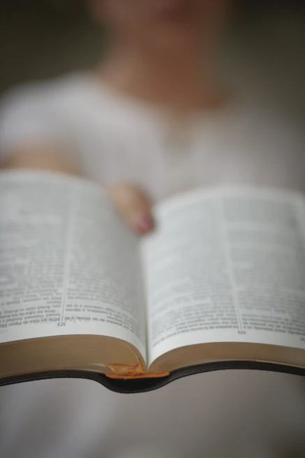 A middle-aged man highlighting text in a book, showing concentration and determination to improve reading speed.