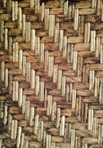 Detailed texture of a woven pattern made from interlaced natural fibers, showcasing an intricate and rustic design.