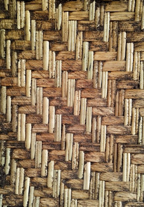 Detailed texture of a woven pattern made from interlaced natural fibers, showcasing an intricate and rustic design.