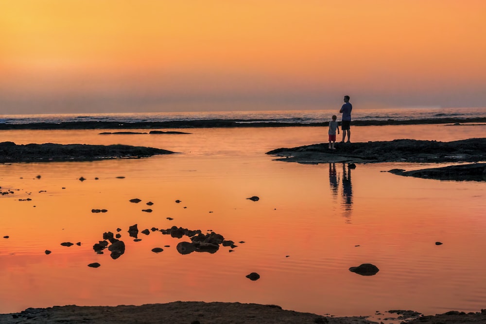 man standing on beach shore during daytime