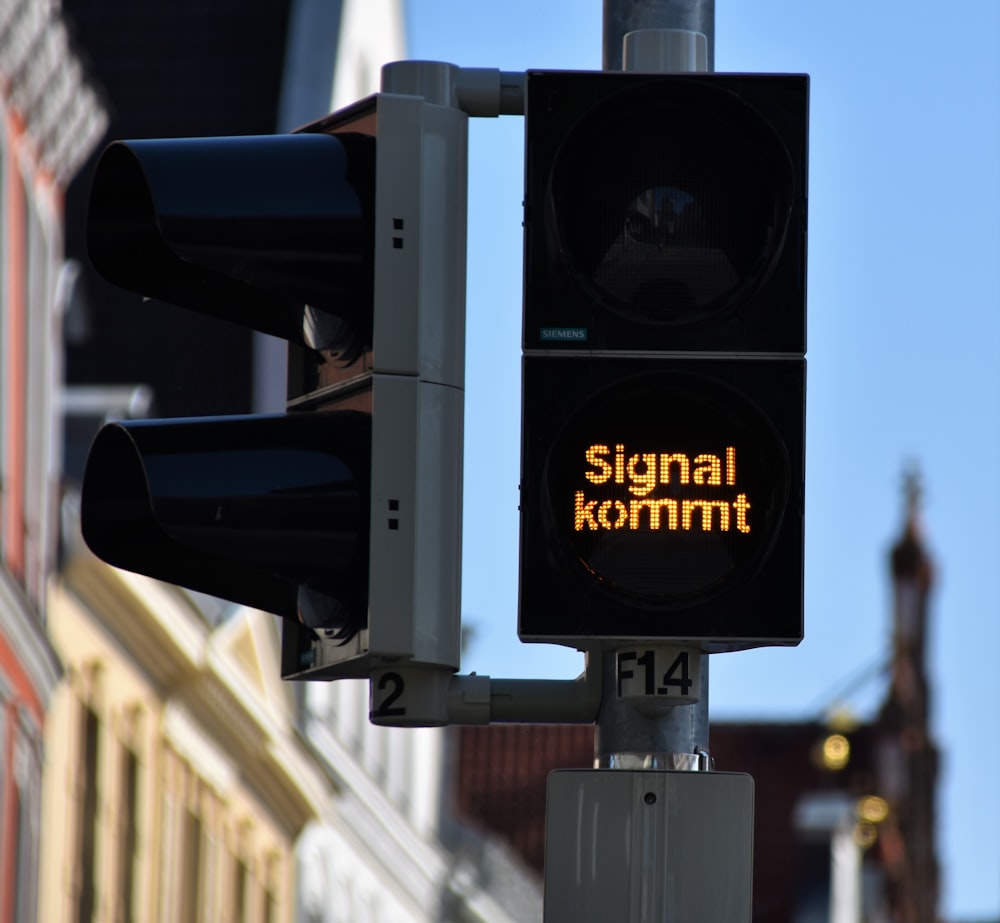 black traffic light with stop sign