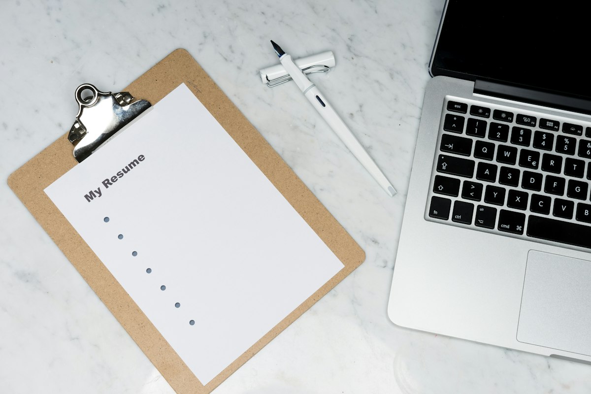 Best AI resume builders compared: polished resume with AI suggestions on a desk
