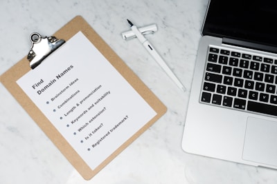 white printer paper beside silver macbook