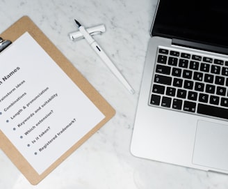 white printer paper beside silver macbook