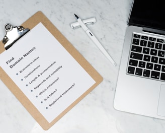 white printer paper beside silver macbook