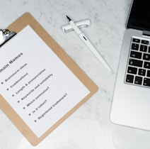 white printer paper beside silver macbook