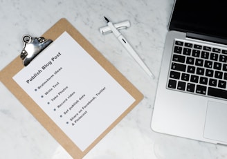 white printer paper beside silver macbook