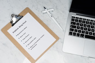 white printer paper beside silver macbook