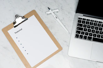 white paper on brown folder beside silver key