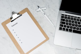 white paper on brown folder beside silver key