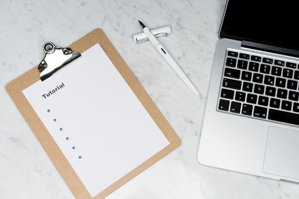 white paper on brown folder beside silver key