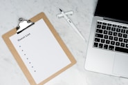white paper on silver laptop computer