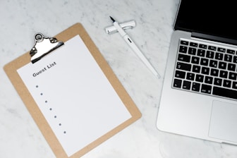 white paper on silver laptop computer