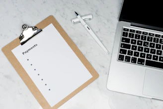 Close-up of hands filling out a recovery worksheet on a clean desk.