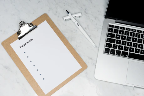 Close-up of hands filling out a recovery worksheet on a clean desk.