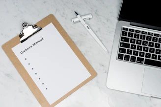 white paper on silver laptop computer