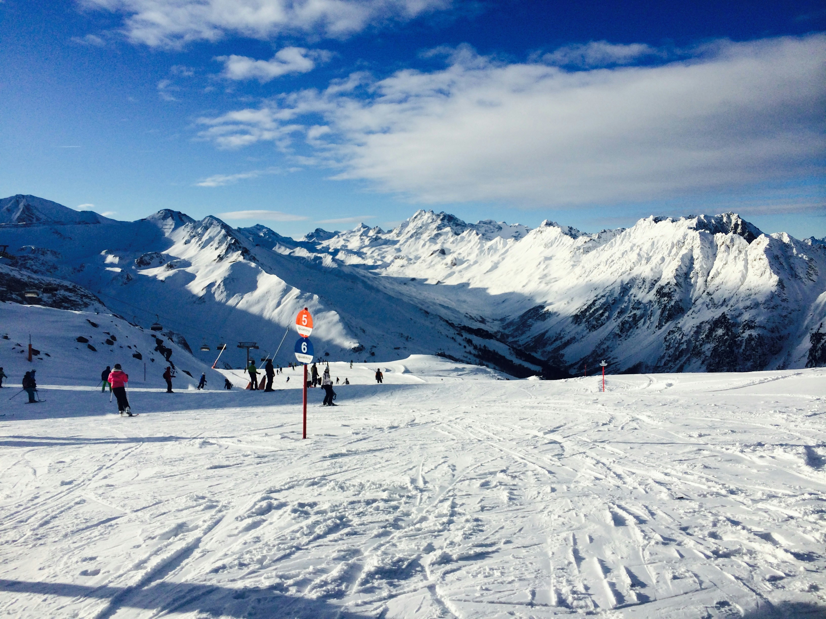 person in red jacket standing on snow covered ground during daytime