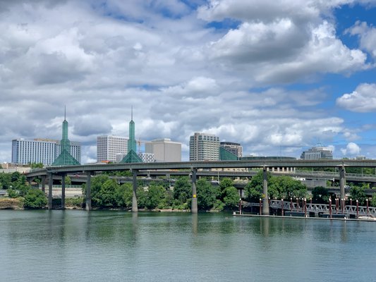 Green trees near body of water under cloudy sky during daytime — Portland, United States