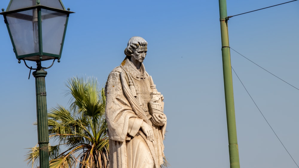 white concrete statue of man