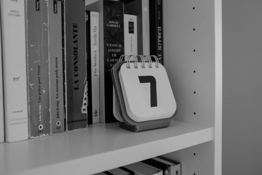 white and black plastic case on white wooden shelf