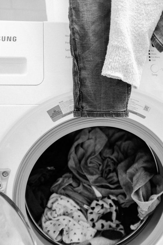 gray and white textile on white front load washing machine