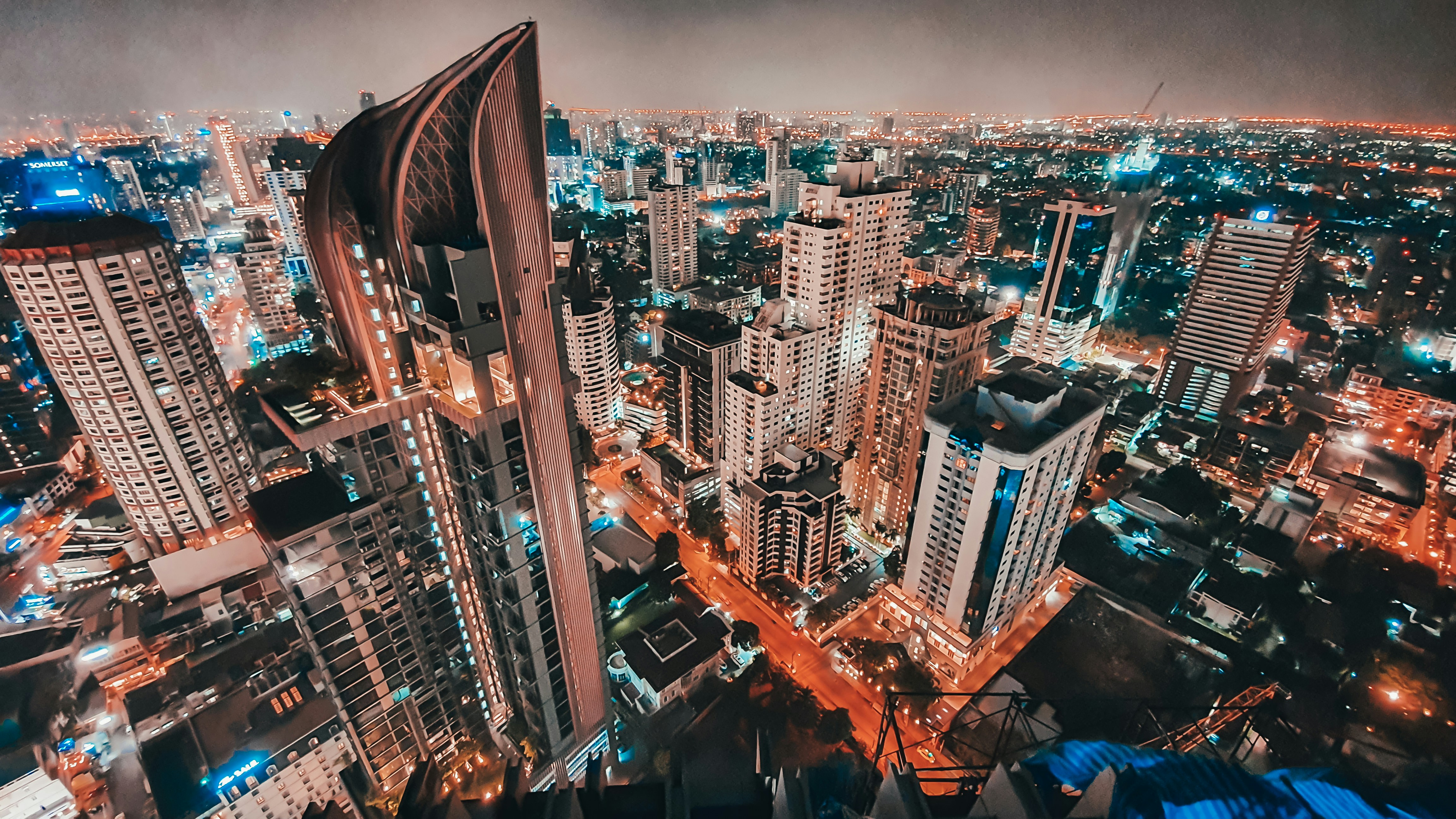 The modern skyline of Bangkok with busy streets below