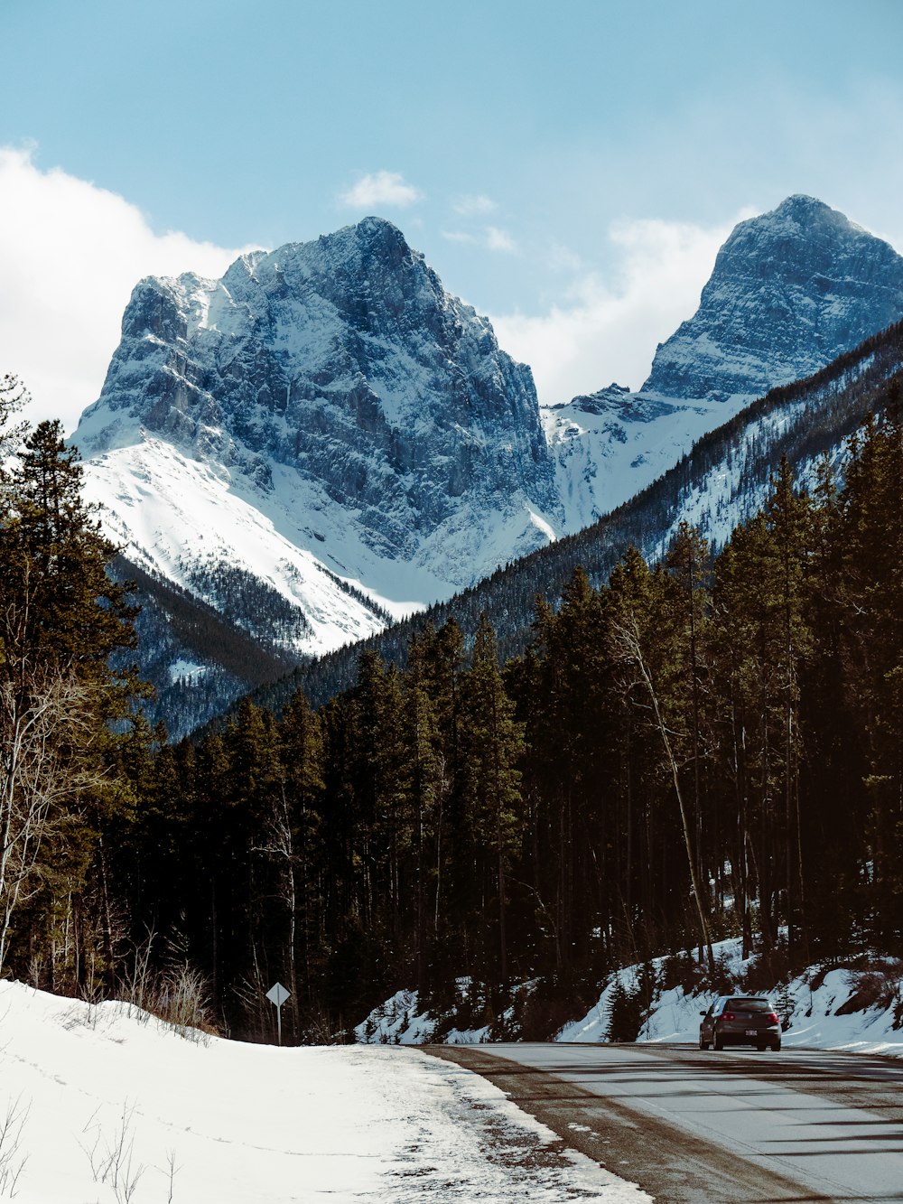 snow covered mountain and trees during daytime