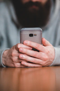 person holding silver iphone 6