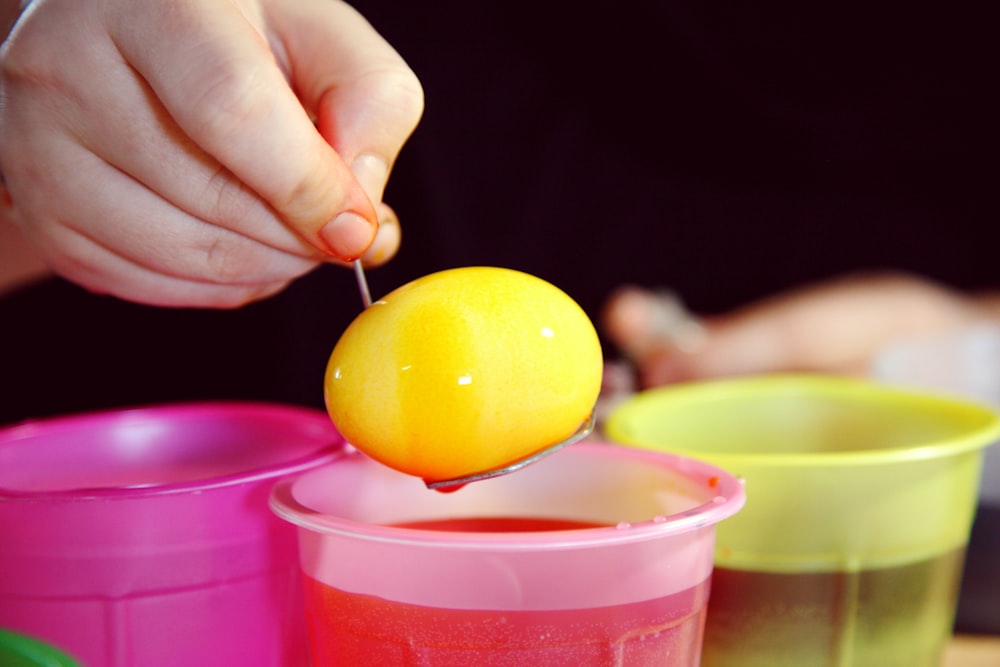 yellow fruit on pink plastic container