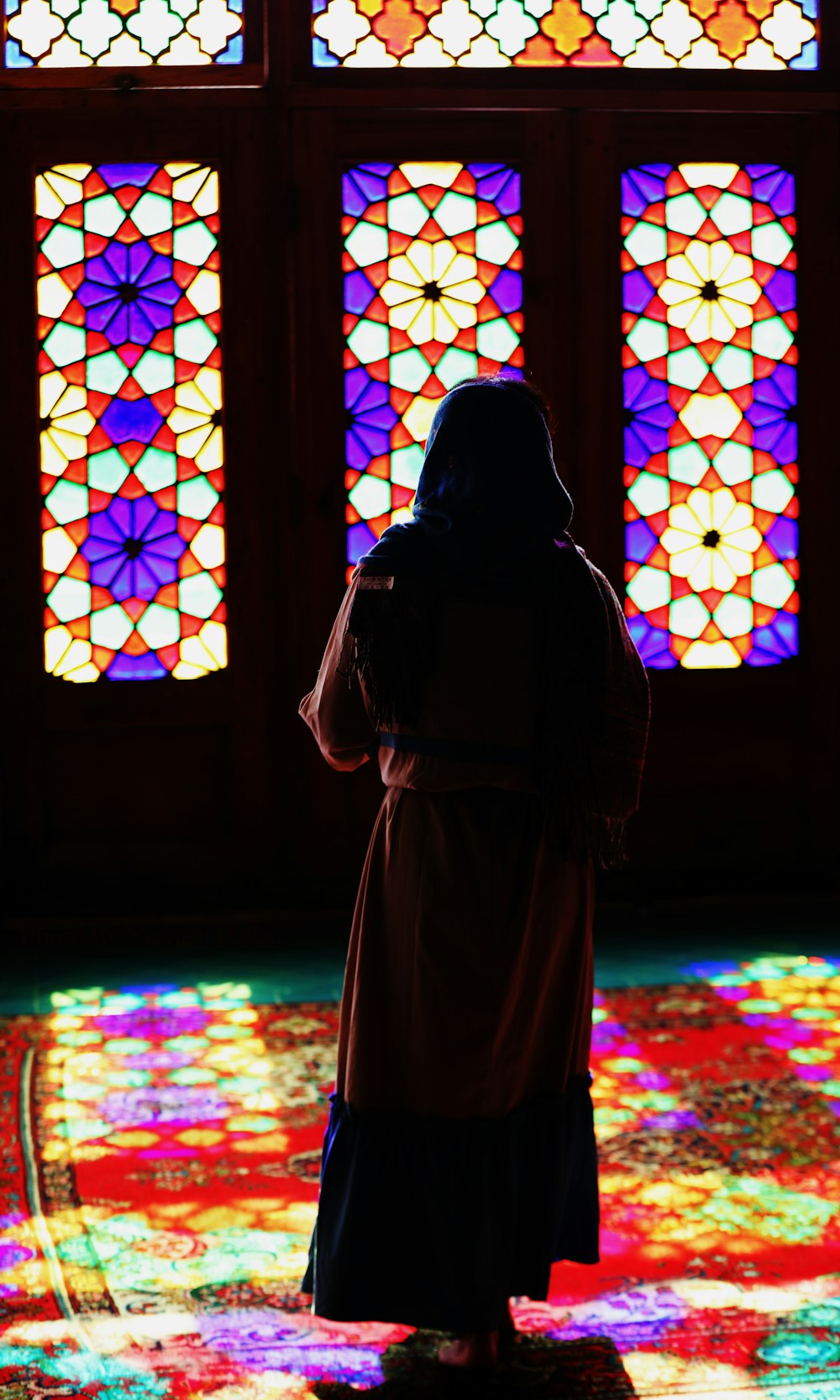 woman in brown hijab standing on brown floor