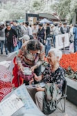 A group of friends excitedly sharing shopping finds outdoors.
