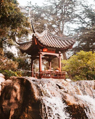 brown wooden gazebo on brown rock