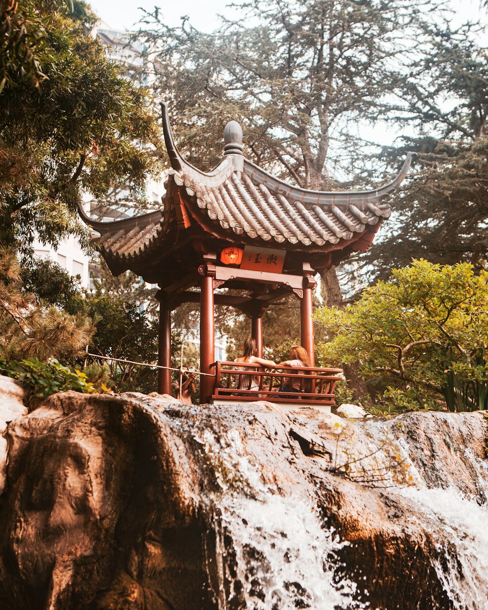 brown wooden gazebo on brown rock