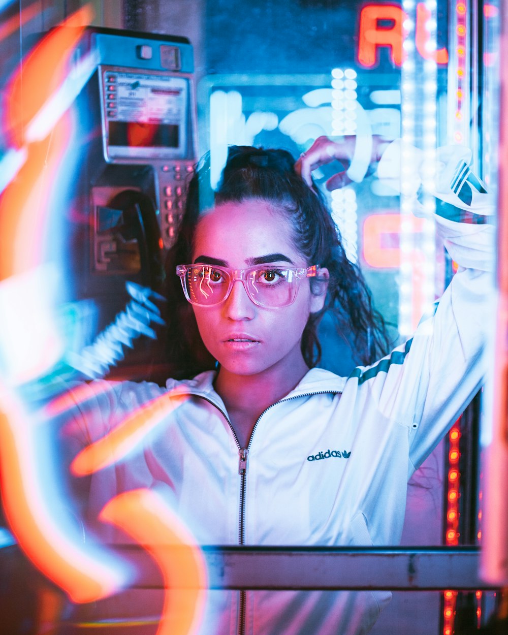 woman in white zip up jacket wearing black framed eyeglasses