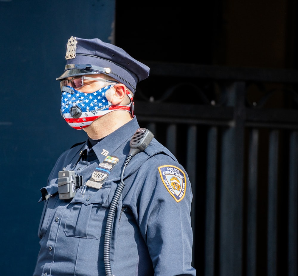 man in black and brown camouflage uniform wearing blue and white mask