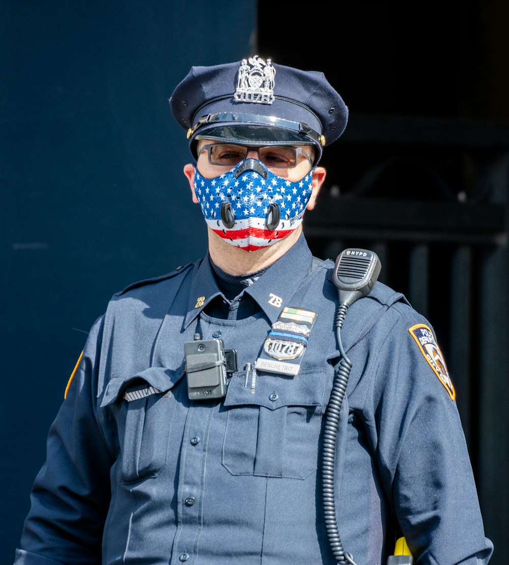 man in black jacket wearing blue and orange mask