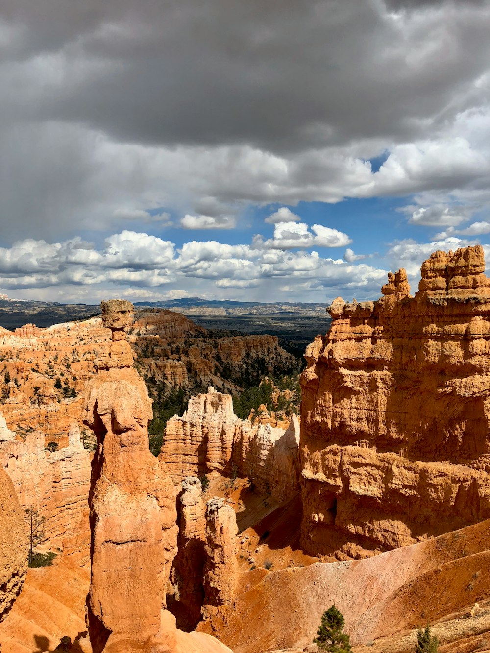 brown rock formation under white clouds and blue sky during daytime