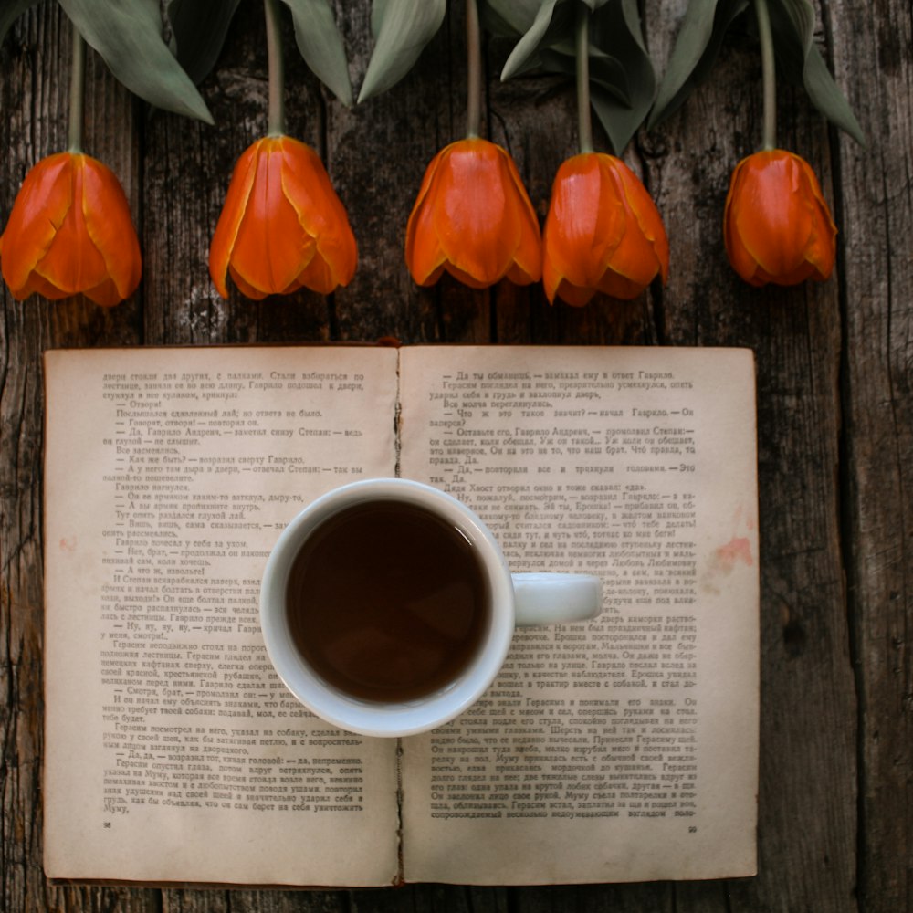 white ceramic mug on white book page