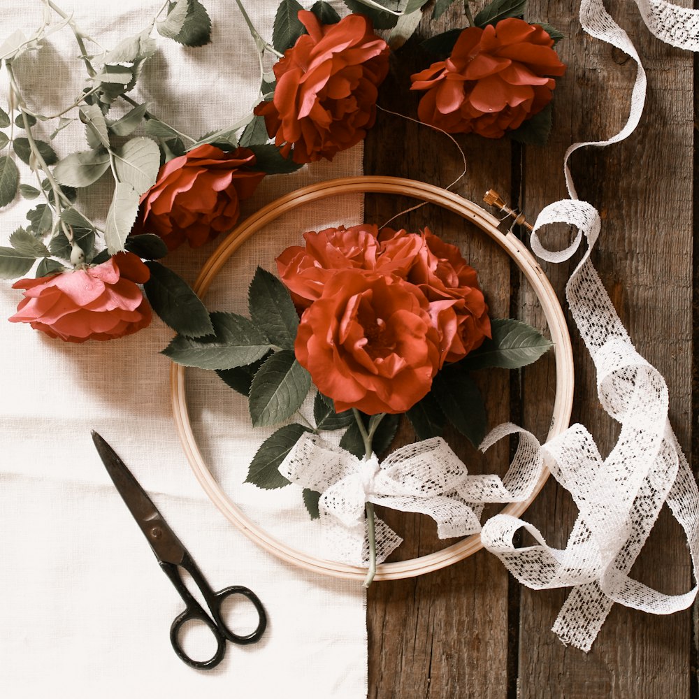 red rose bouquet on brown wooden table