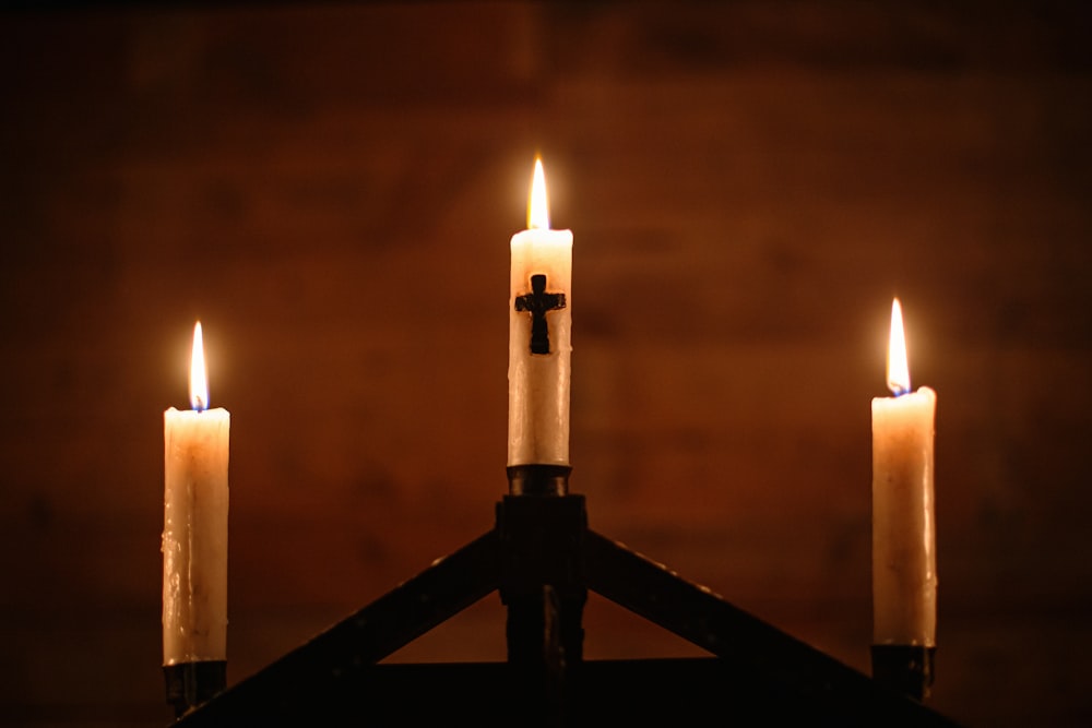 white candles on black stand