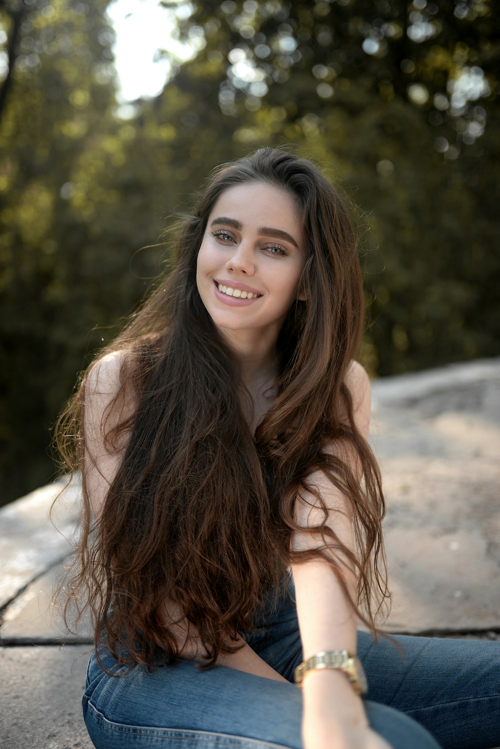 woman in white tank top smiling