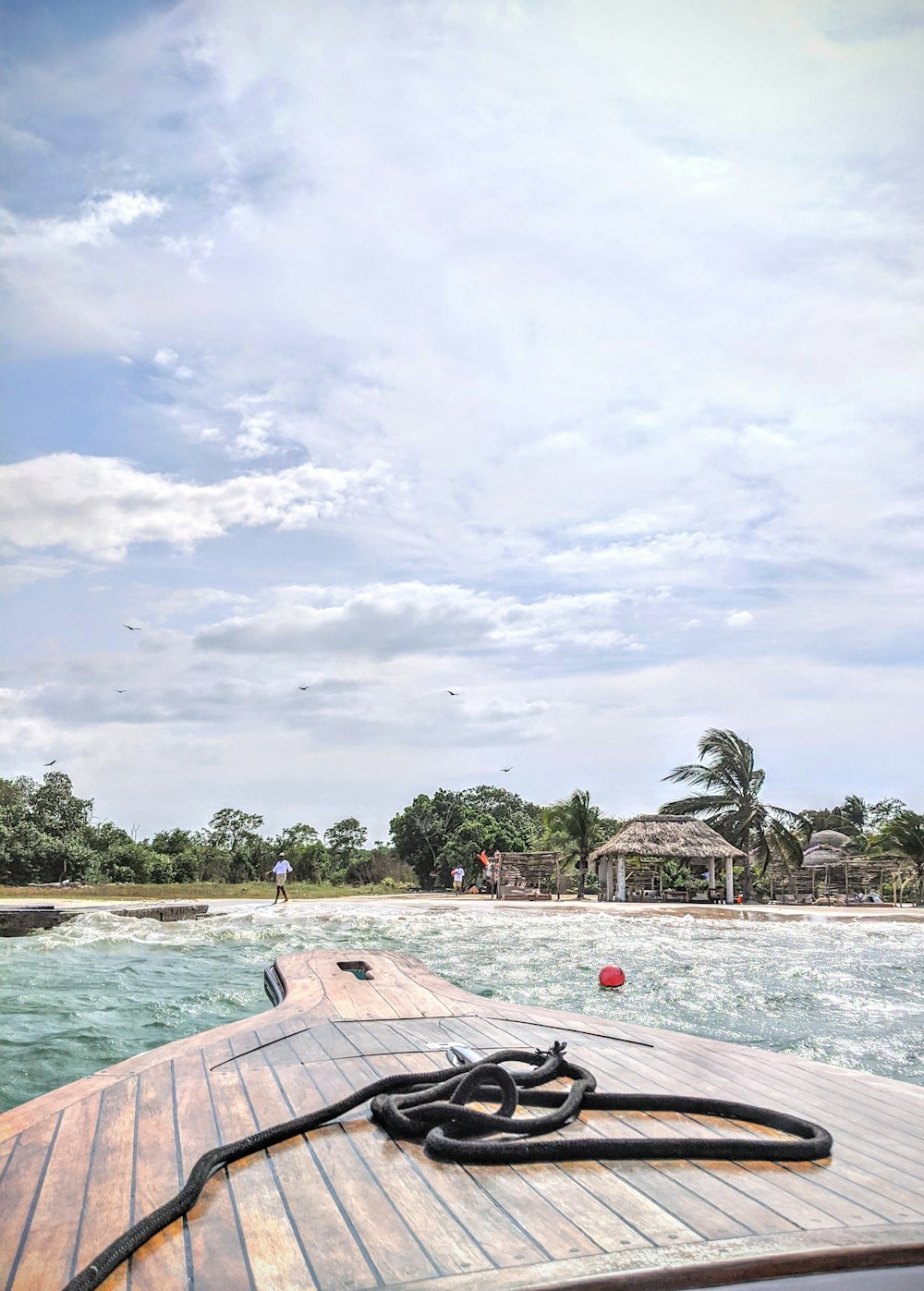 brown wooden boat on sea shore during daytime