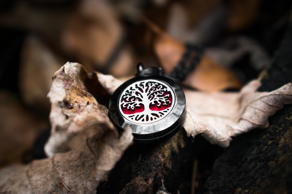 black and silver round analog watch