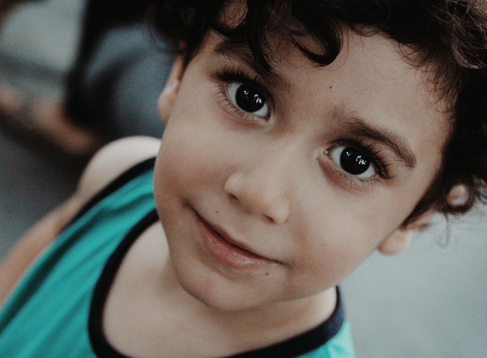 boy in white and teal shirt