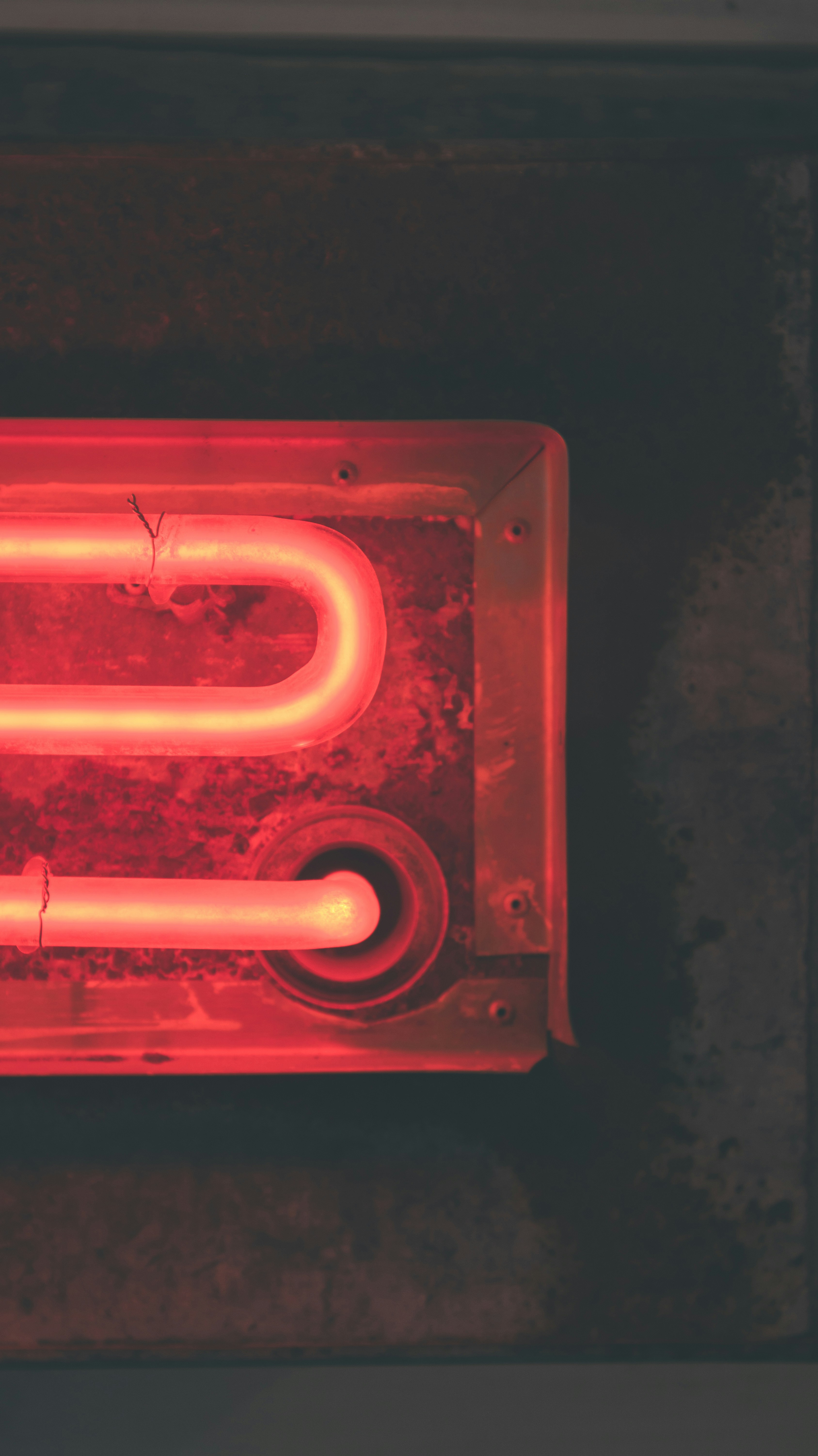red metal tool on black surface