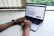 Close-up of hands typing on a sleek laptop with a clean desk background.