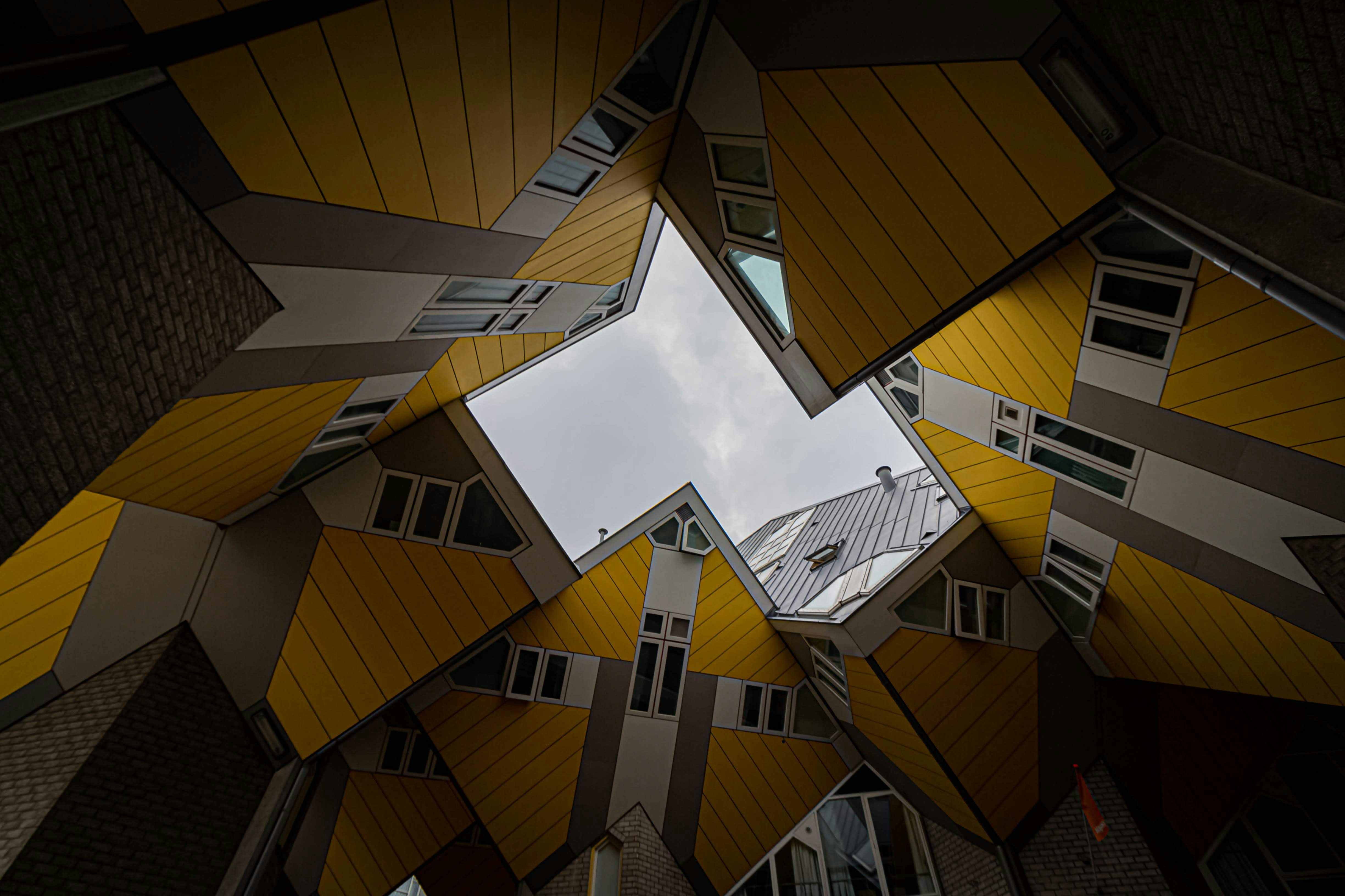 brown and white concrete building under white clouds during daytime