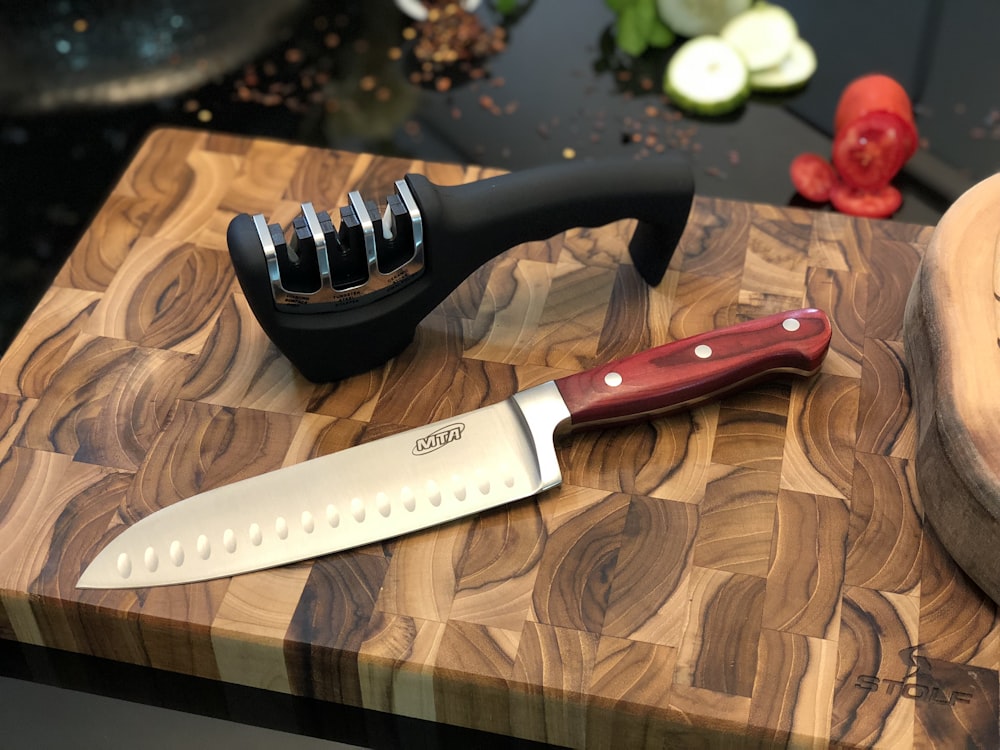 black handled knife beside black and white round ornament