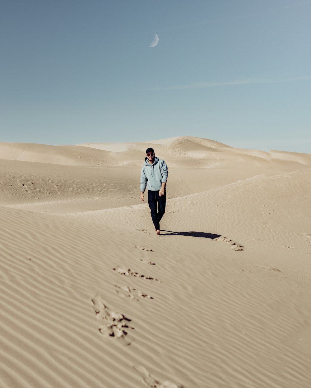 woman in white jacket walking on desert during daytime