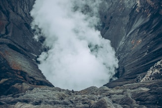 gray rocky mountain with white clouds
